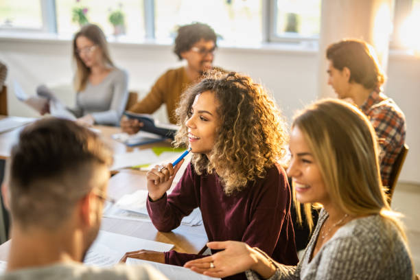 istock Happy college students learning together in the classroom. 1210775674