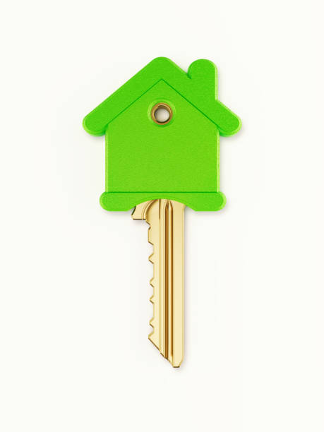 istock House Shaped Bronze Key Covered with Green Plastic on White Background 1210775859