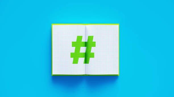 istock Open Green Book with Hashtag Symbol Sitting Over Blue Background 1210777817