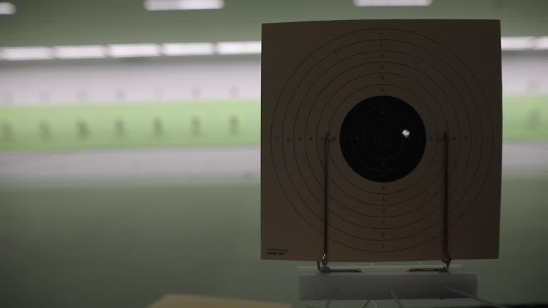 Shooting target with bullet hole at shooting range