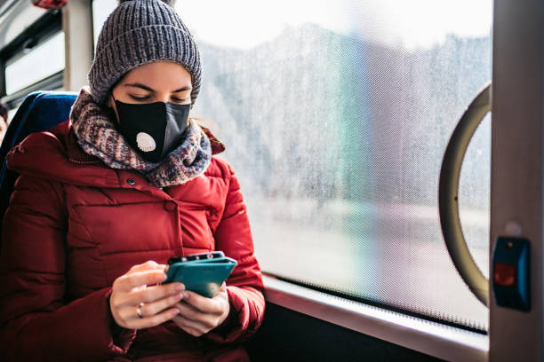 istock Woman in bus wearing face mask 1210783534
