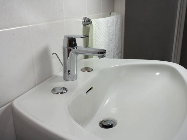 istock tap faucet in basin 1210783940