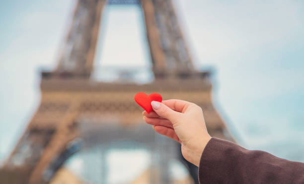 istock Heart in hands near the Eiffel Tower in Paris. Selective focus. 1210785761