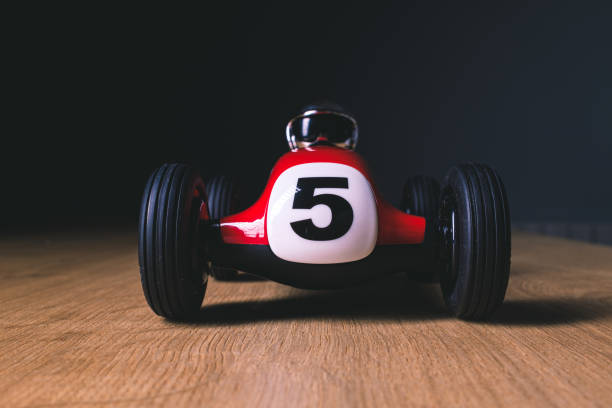 istock Number five printed on a red toy racing car over a wooden surface 1210785766