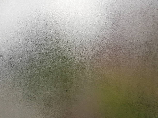 transparent glass with fog up and water drop on it during winter season with cold hand writing letter on it. close up shot of natural beauty effect. background and wallpaper concept. - condensation steam window glass imagens e fotografias de stock