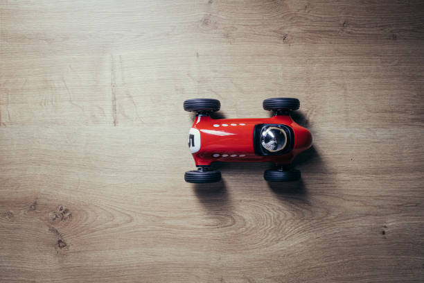 istock Red toy racing car on a hardwood surface 1210786101