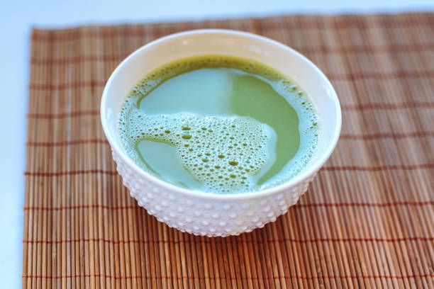 istock Green matcha tea in a bowl on bamboo mat 1210786111