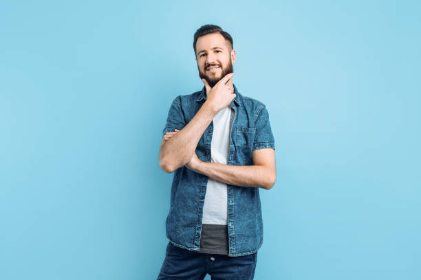 istock Attractive man with a beard on a blue background 1210788213