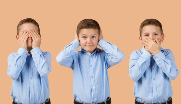 Three rural Indian children sit on a low barrier in a lush green cornfield, playfully posing with the gestures of see no evil, speak no evil, and hear no evil. The cheerful scene reflects innocence, unity, and rural childhood fun.