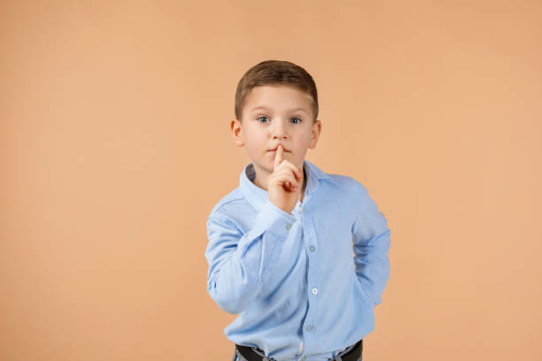 istock child showing shh sign 1210788565