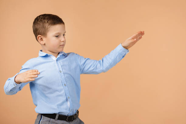 istock little cute school boy dancing 1210788731