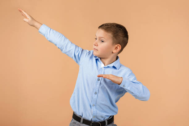 istock little cute school boy dancing 1210788840
