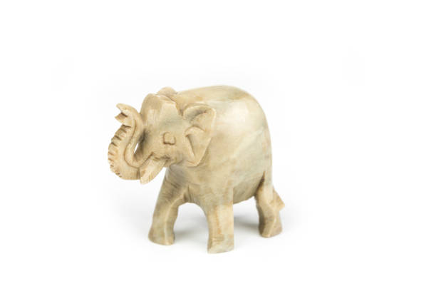 istock Carved marble elephant on a white background 1210793414
