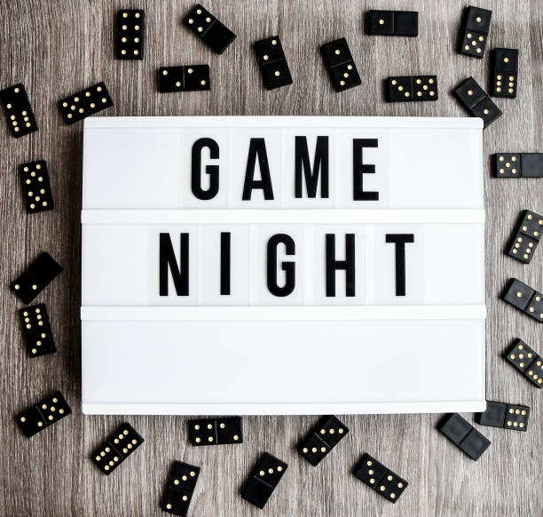 istock Game night text frame of dominoes with copy space inside on wooden background, table game 1210793460