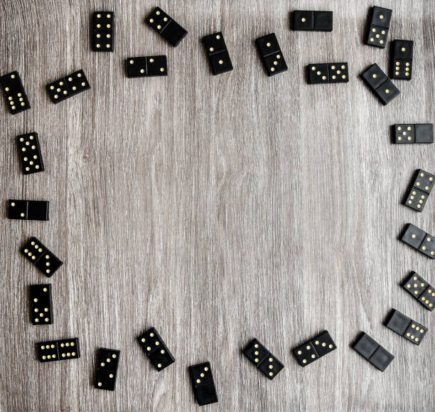 istock frame of dominoes with copy space inside on wooden background, table game 1210793542