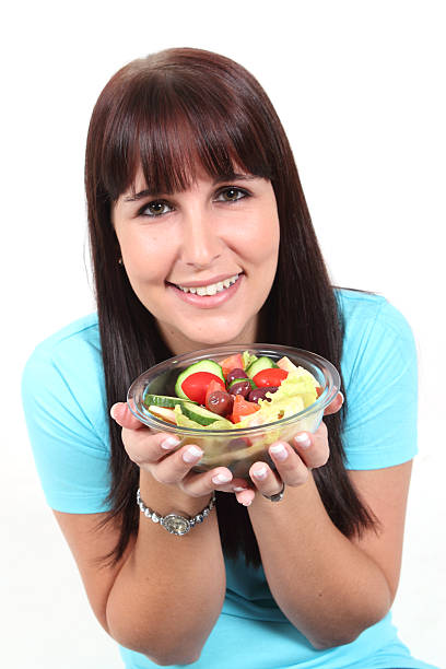 istock Woman holding a bowl with salad 121079370