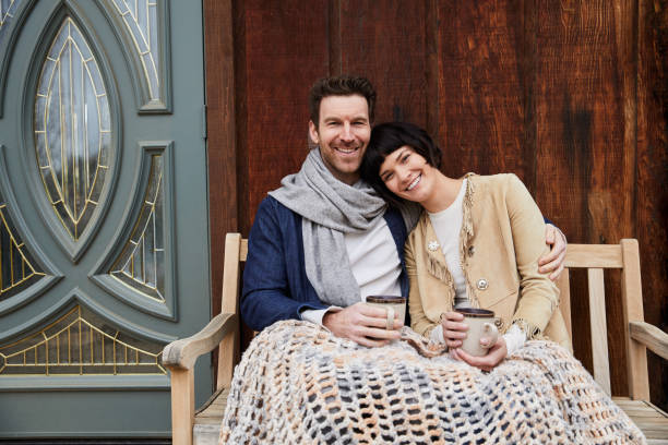 istock Smiling young couple having coffee outside on a cool morning 1210794990