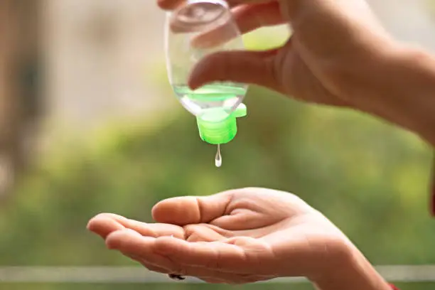 human hands using sanitizer to clean himself