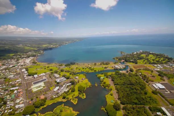 The city of Hilo on the Big Island, Hawaiian archipelago, from the air with blue bay on a sunny day