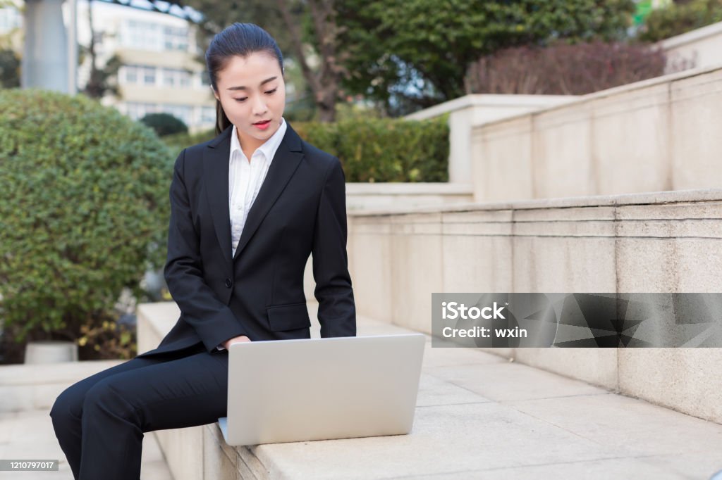 girl using a laptop computer, business women pretty girl is a civil servant, using laptop outdoors Civil Servant Stock Photo