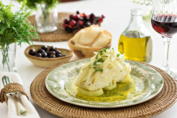 a codfish with potatoes, onion and parsley - bacalhau imagens e fotografias de stock