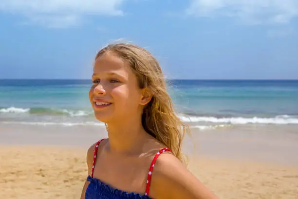 Young blond hair girl smiling at the beach