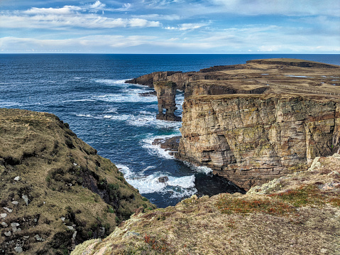 Yesnaby is an area in Sandwick, on the west coast of Orkney Mainland, Scotland, south of Skara Brae. It is renowned for its spectacular Old Red Sandstone coastal cliff scenery which includes sea stacks such as Yesnaby Castle, blowholes, geos and frequently boiling seas.
