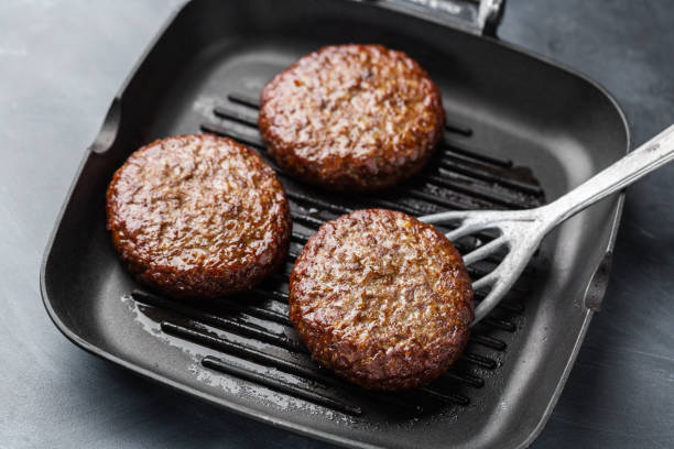 istock Cooking process of beef patties on pan 1210805041