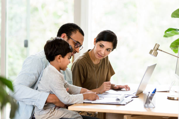 istock Small family use laptop together 1210807249