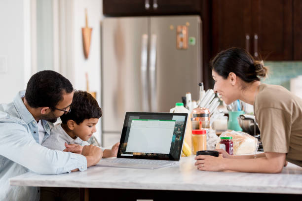 istock Caring dad show his son something on laptop 1210807262