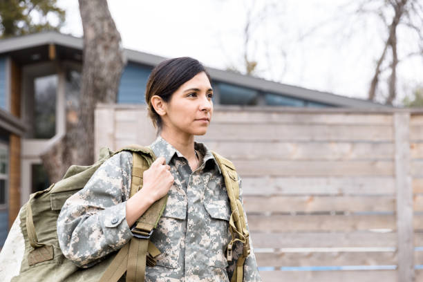 istock Serious female soldier leaving home 1210807296