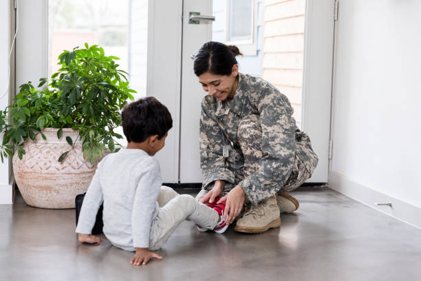 istock Before going to work, single mom helps son with shoes 1210807978