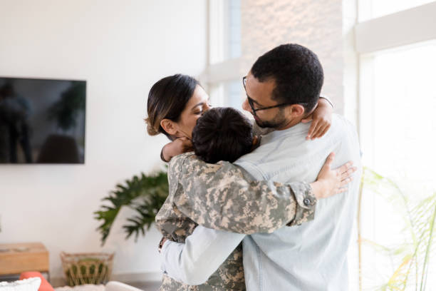 istock Mother in uniform and father hug unrecognizable son 1210807985
