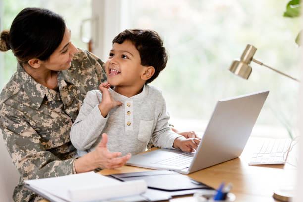 istock Excited little boy helps his mom use computer 1210808081