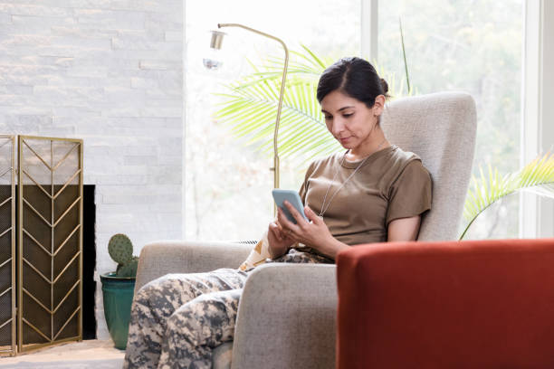 istock Serious female soldier uses smartphone 1210808118
