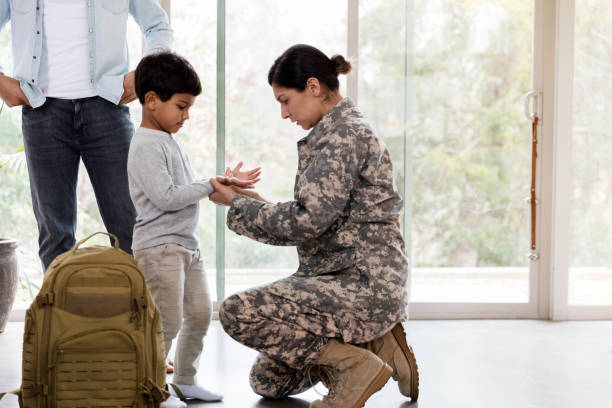 istock Female soldier examines her son's dirty hands 1210808123