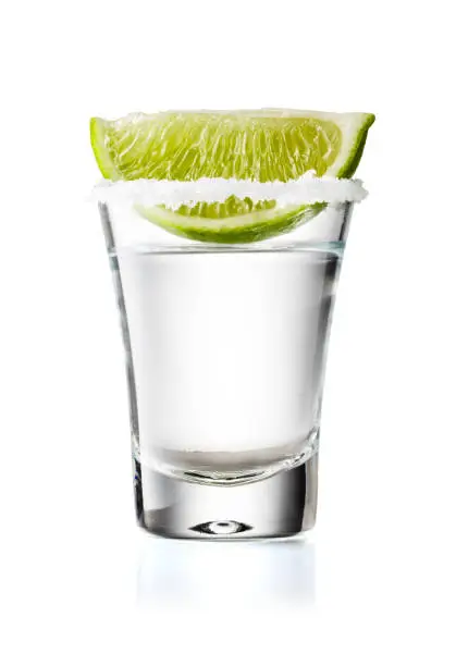 Tequila Glass Shot With Lime Slice and Salty Rim, Isolated on White Background With Clipping Path