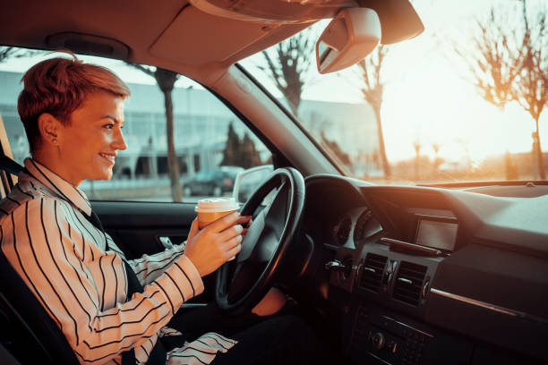istock Smiling woman in a car 1210811154