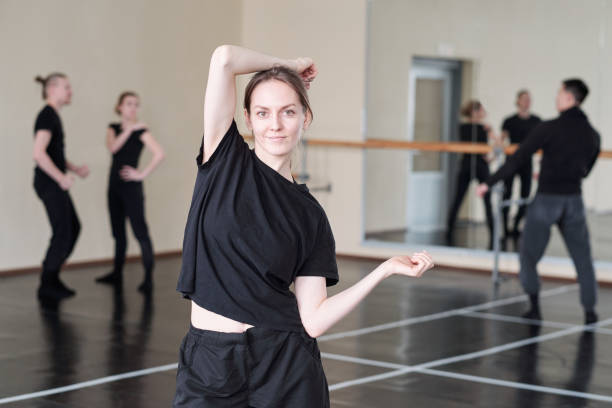 istock Pretty young student of modern ballet dancing course in black activewear 1210811310
