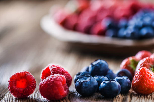istock Forest fruits in wooden bowl. 1210813295