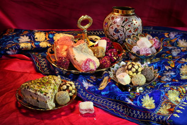 istock Oriental sweets on a red background in copper utensils 1210815876