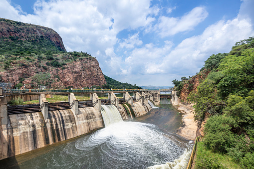 Hartbeespoort dam / lake wall with sluice gate open and water gushing down, in the North west province of South Africa.