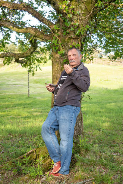 istock senior man relaxing in rural setting 1210816960