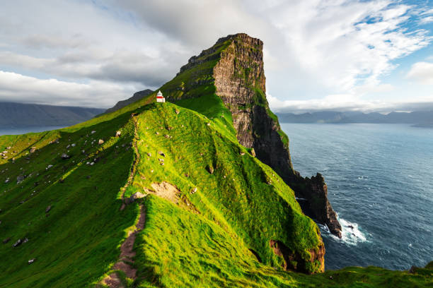 Kallur lighthouse on green hills of Kalsoy island Kallur lighthouse on green hills of Kalsoy island, Faroe islands, Denmark. Landscape photography faroe islands photos stock pictures, royalty-free photos & images