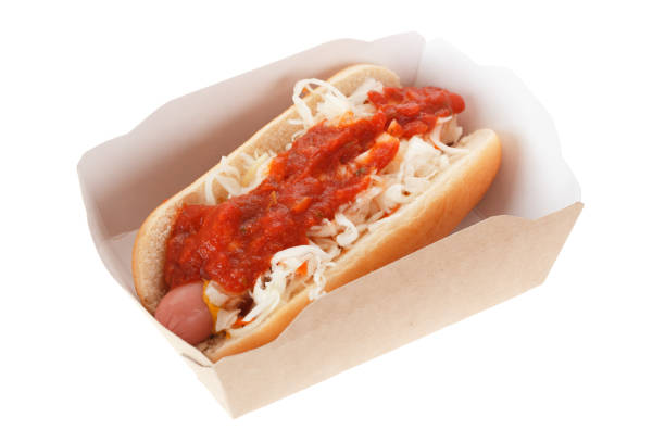 istock Hot dog with cabbage, mustard and tomato sauce isolated on white background. 1210817607