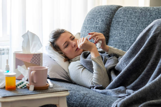 istock Sick woman with flu at home 1210818712