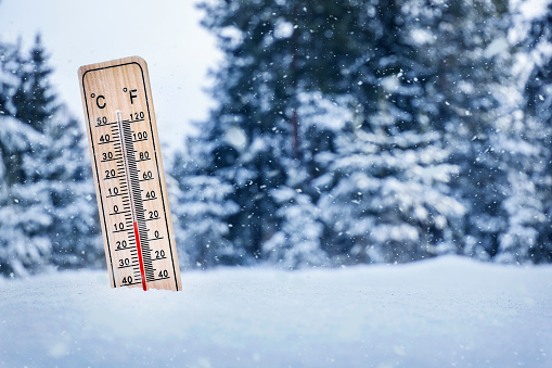 Thermometer in winter. Thermometesr on snow. Temperature below zero.