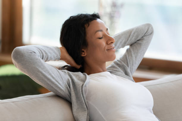 istock Calm biracial woman relax on sofa taking nap 1210820245