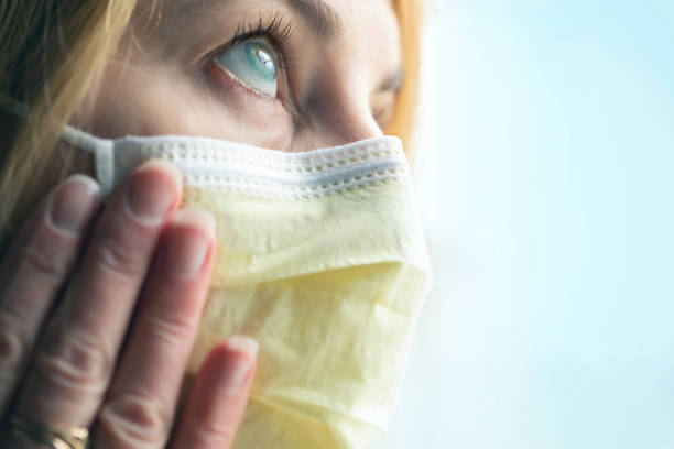 istock Woman Touching Her Virus Protection Face Mask 1210820248