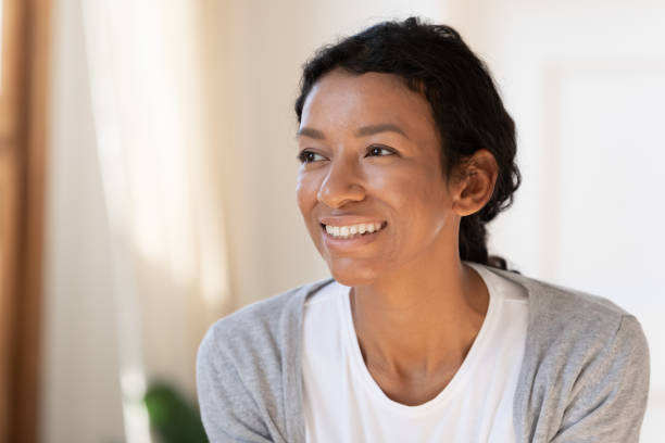 istock Happy african American woman look in distance dreaming 1210820249